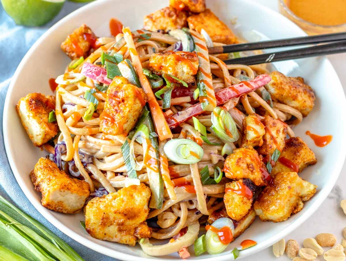 Peanut noodles with fried tofu and chopsticks