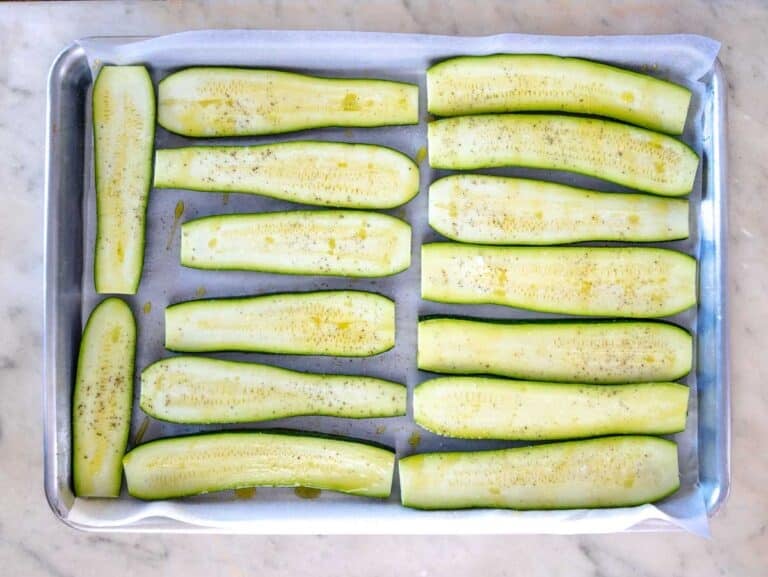 sliced zucchini on a baking tray