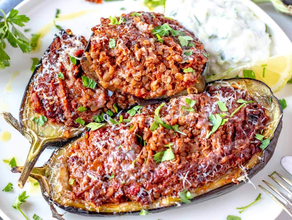 Stuffed eggplant cut in half with fresh parsley