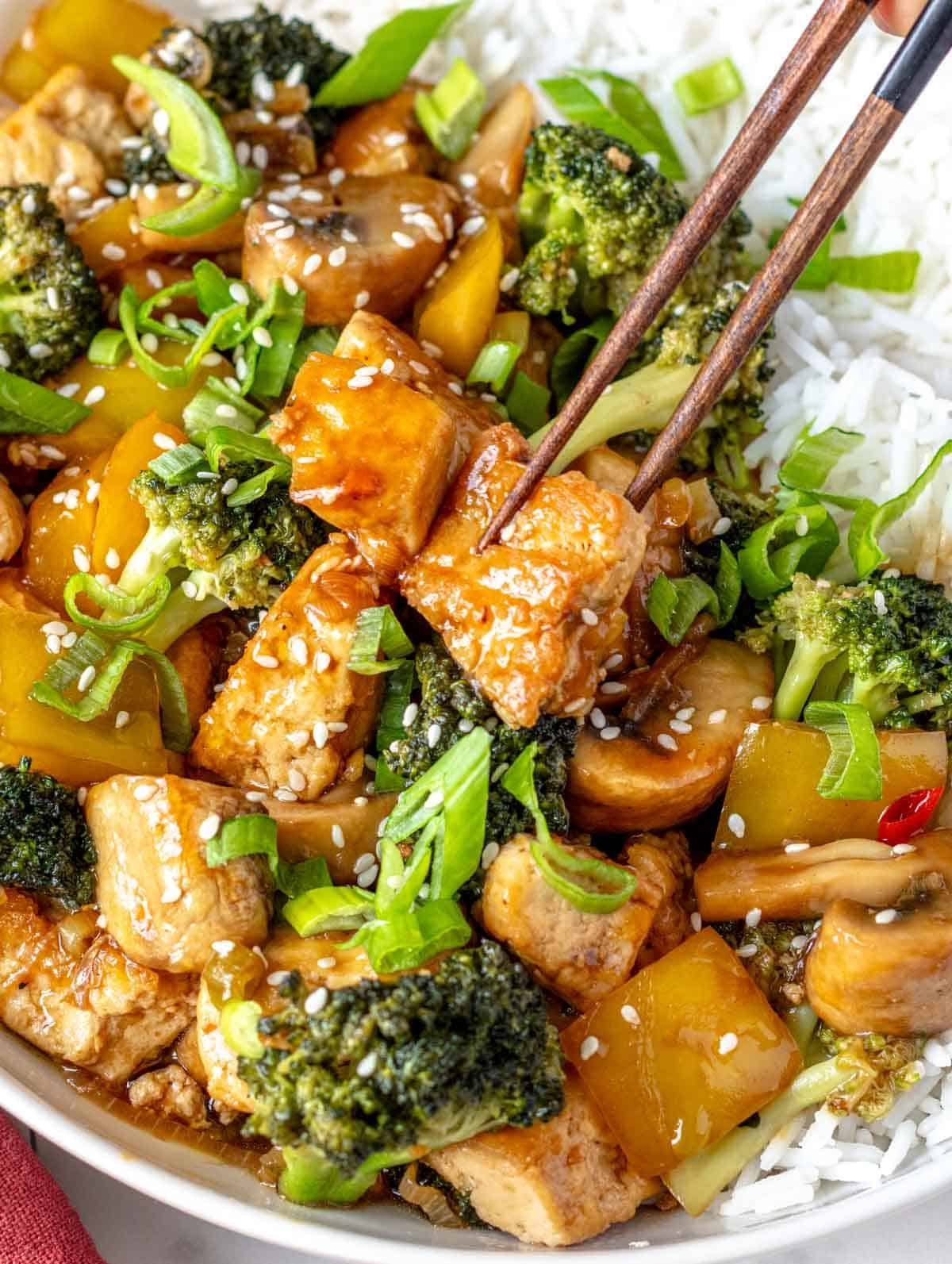 Tofu stir fry with broccoli and chopsticks