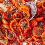 Tomato confit with tender roasted tomatoes and basil in natural window light.