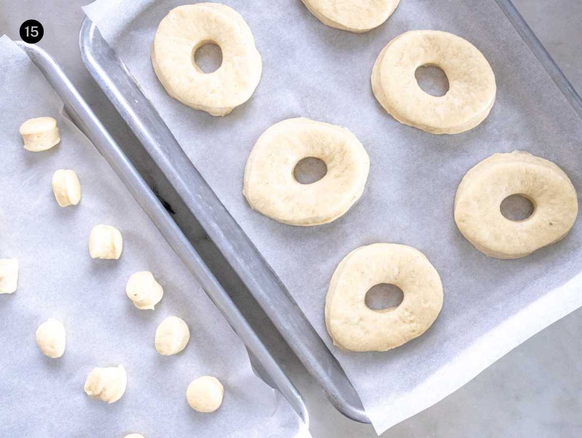 donuts proofing a second time on baking trays