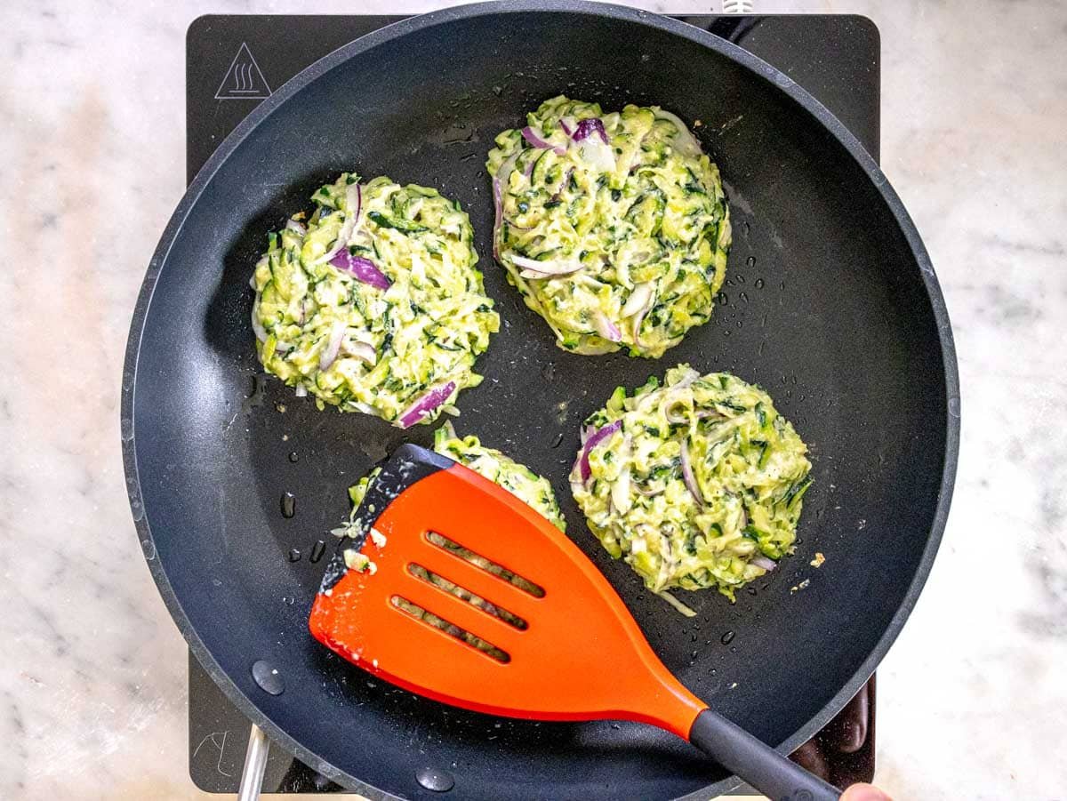 cooking patties on a pan with olive oil