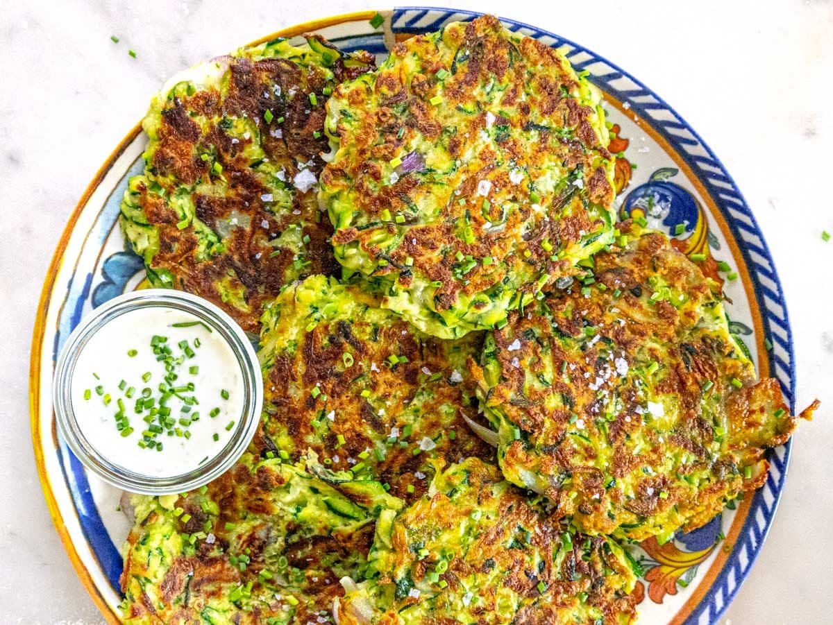 Zucchini fritters after cooking with yogurt sauce