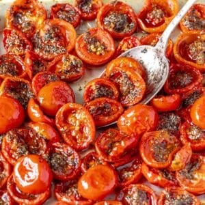 confit tomatoes with dried herbs and a spoon