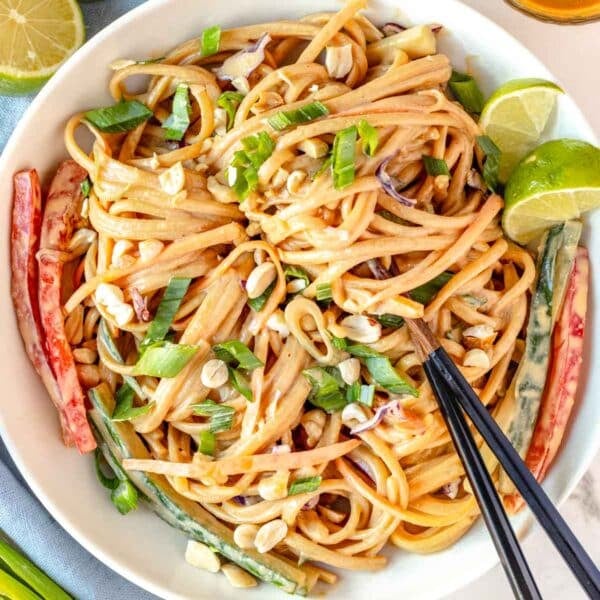 peanut noodles with chopsticks and vegetables