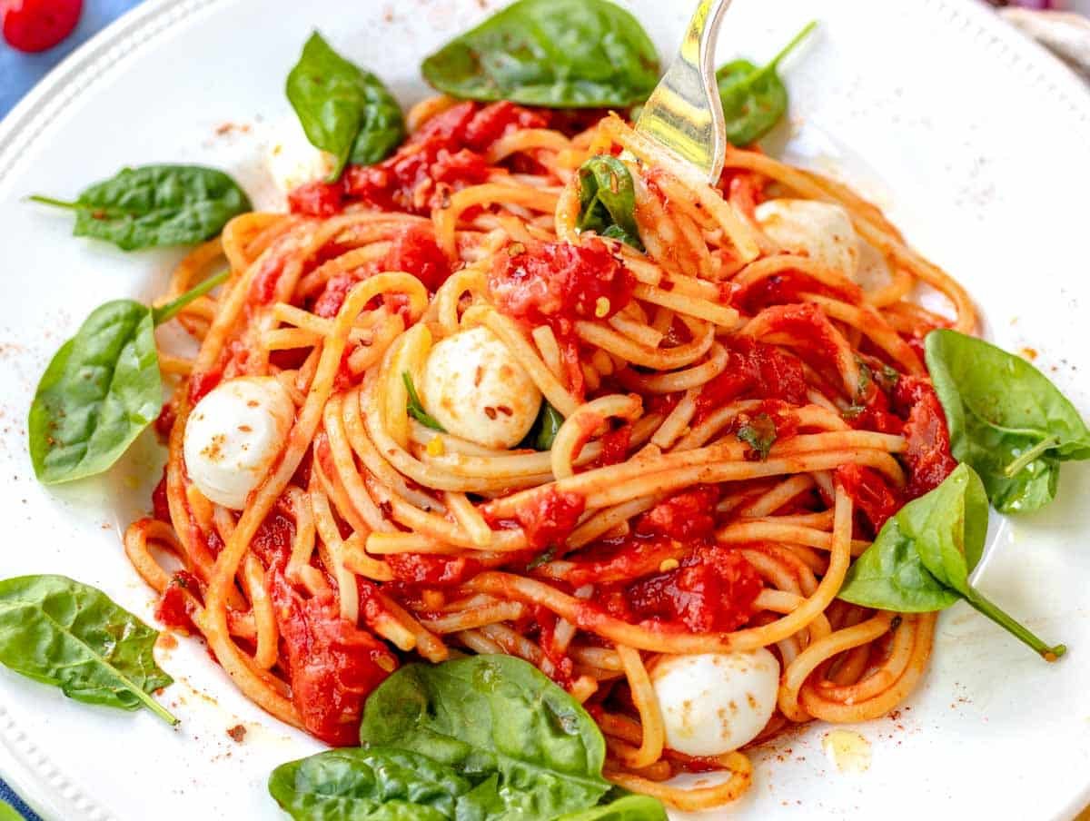 pomodoro pasta with mozzarella balls and spinach