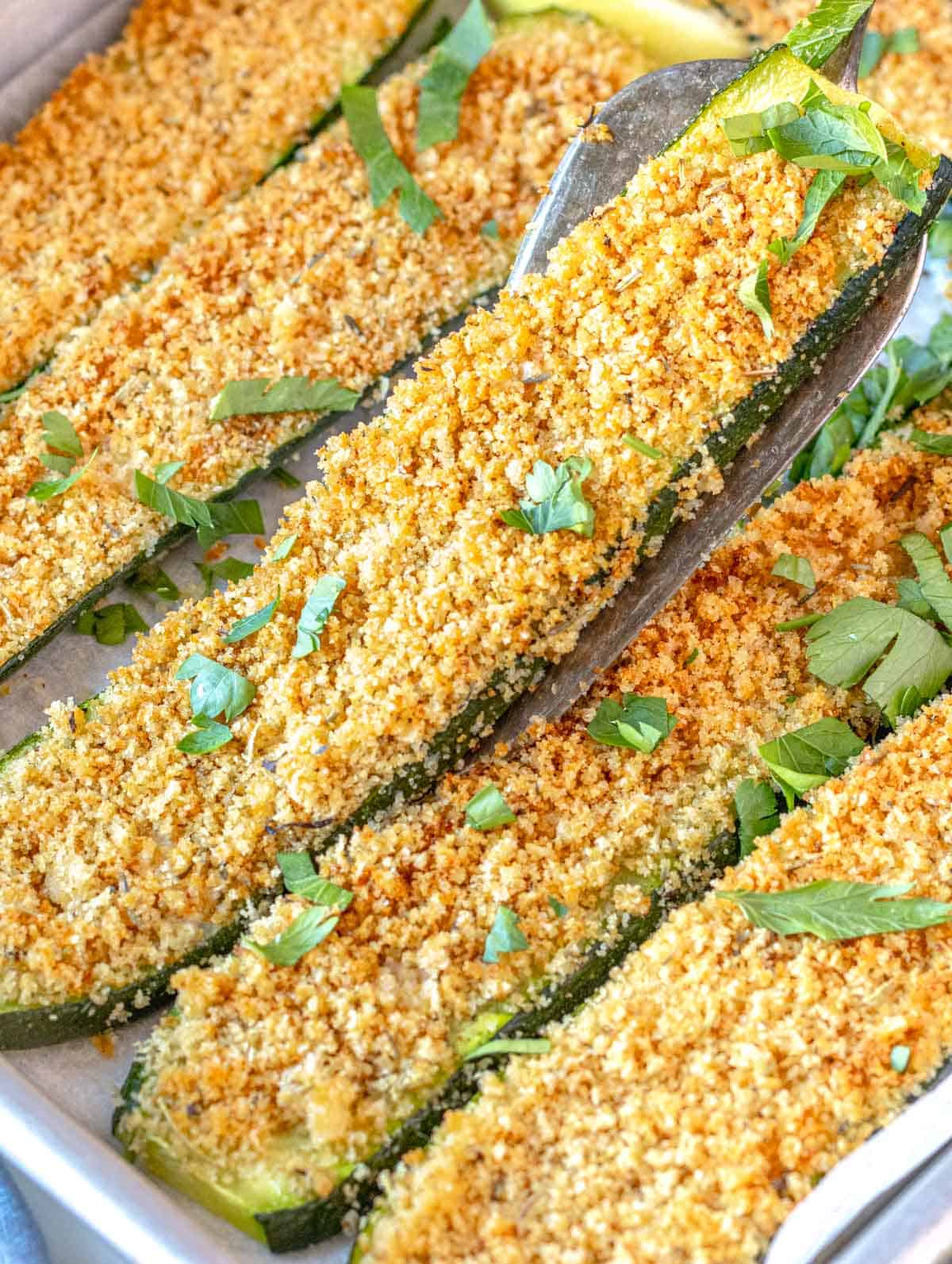 roasted zucchini with breadcrumbs and fresh parsley on a tray