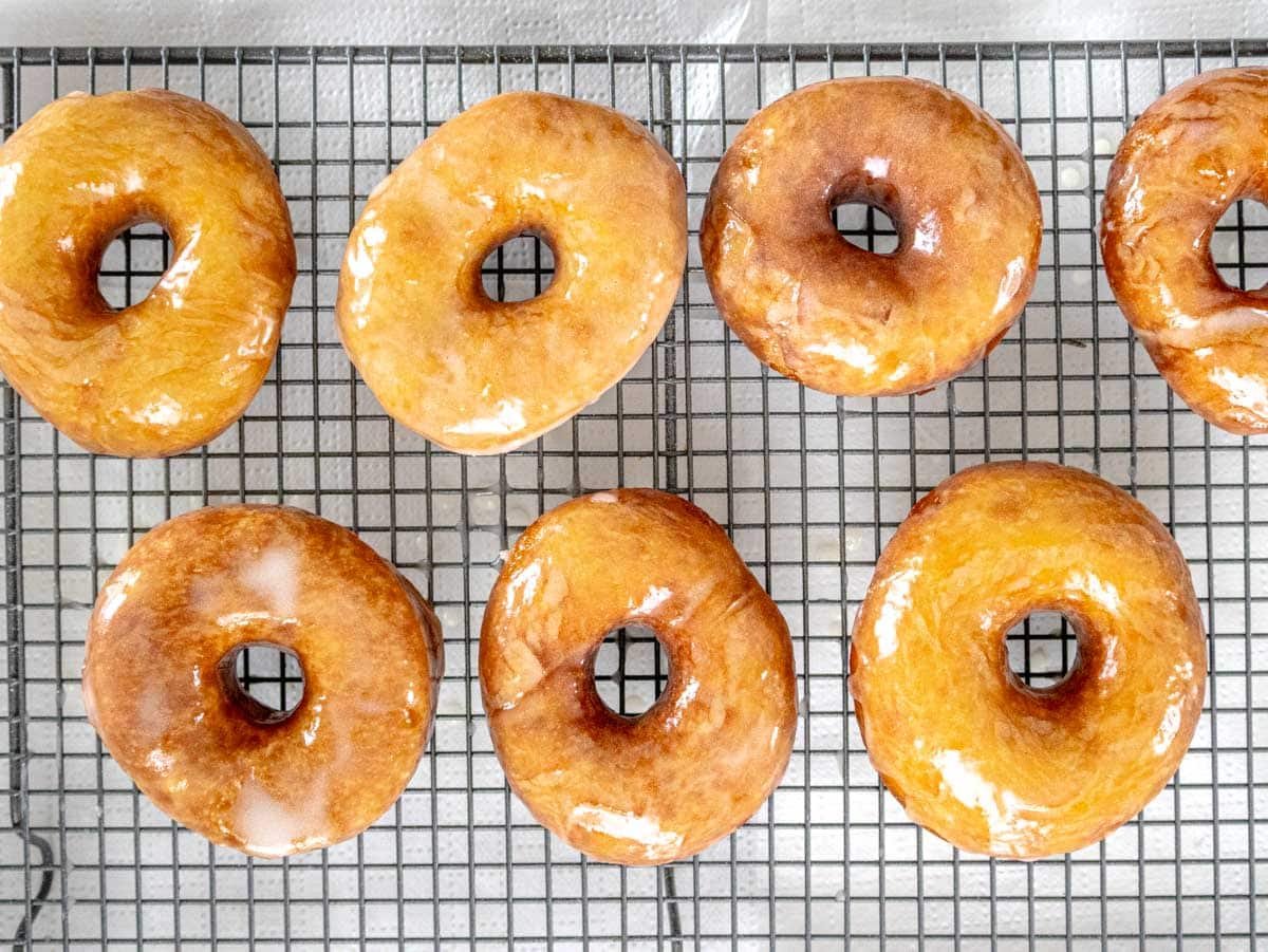 glazed vegan donuts on a cooling rack