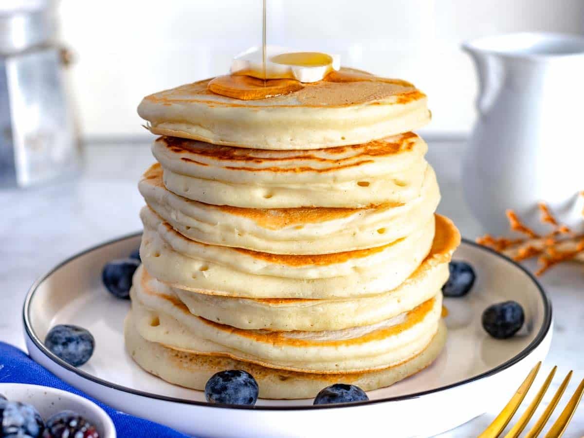 vegan pancakes with blueberries and a slice of vegan butter.