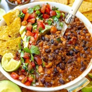 Black bean soup with a white spoon