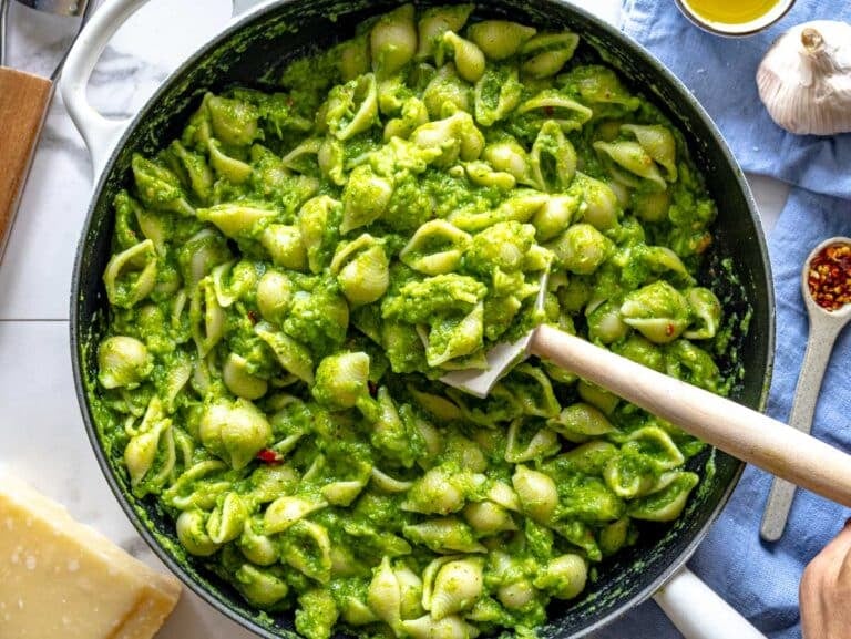 pasta in a skillet mixed with the broccoli sauce