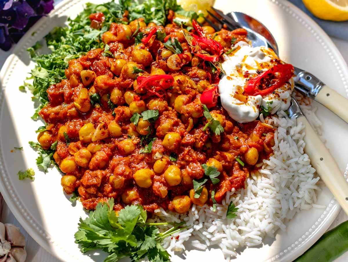 Chana masala with rice, kale, and cutlery