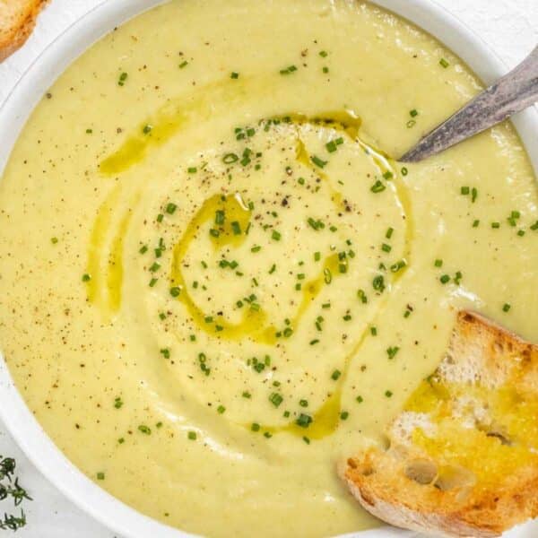 Cozy bowl of creamy potato leek soup with skyr garnished with chives.