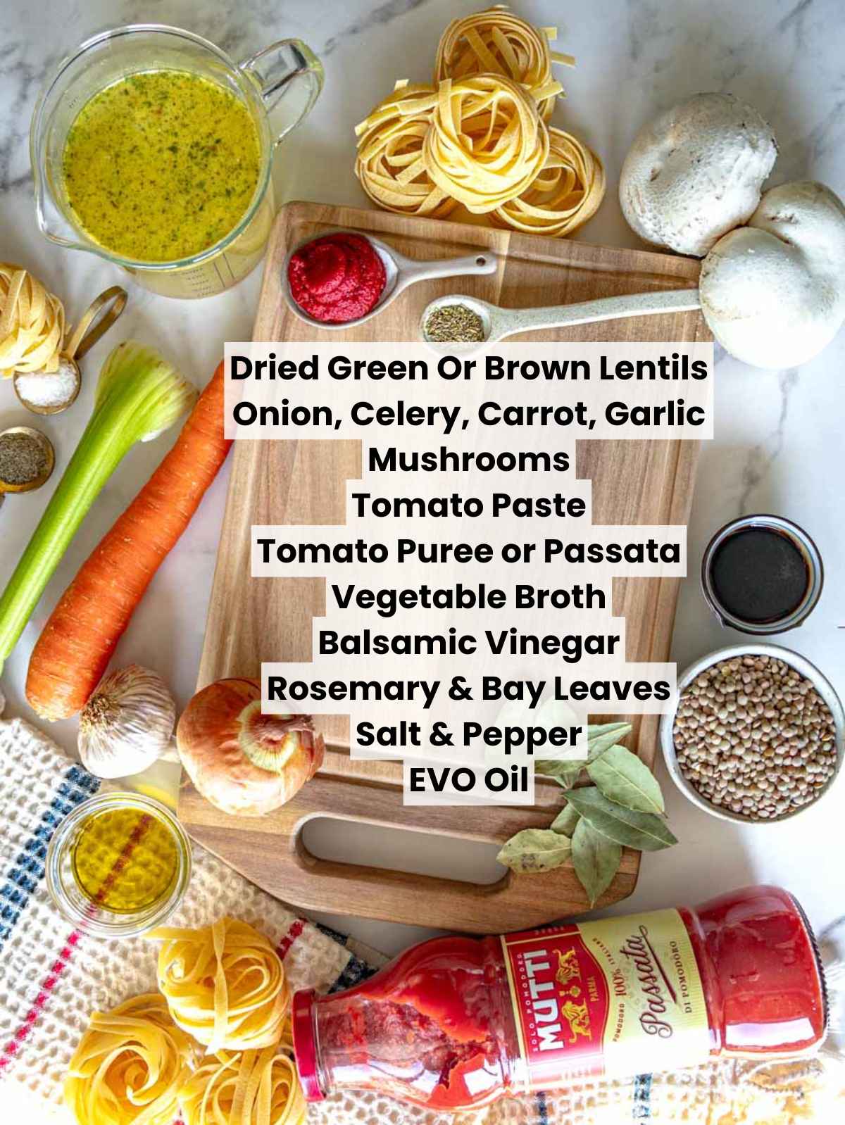 Ingredients for lentil Bolognese arranged on a marble surface, including dried lentils, mushrooms, tomatoes, vegetables, herbs, and seasonings .