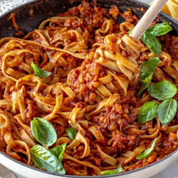 Lentil Bolognese with fettuccine pasta and fresh basil.