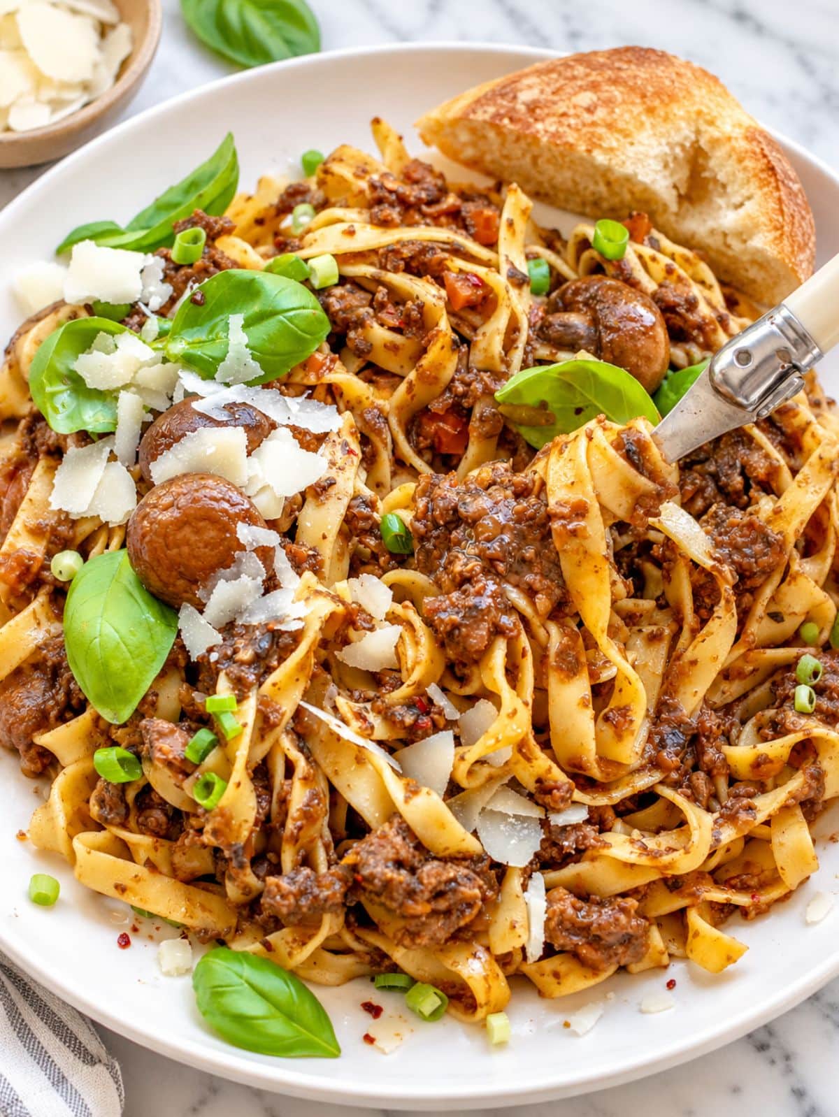 Mushroom ragu with fettuccine, fresh basil, parmesan, and olive oil.