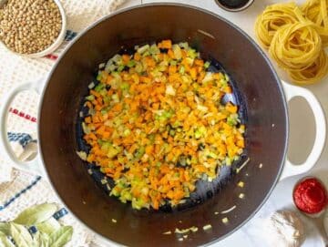 Step 1 Finely chopped onion, celery, carrot, and garlic cooking in olive oil in a large pot until beginning to soften.