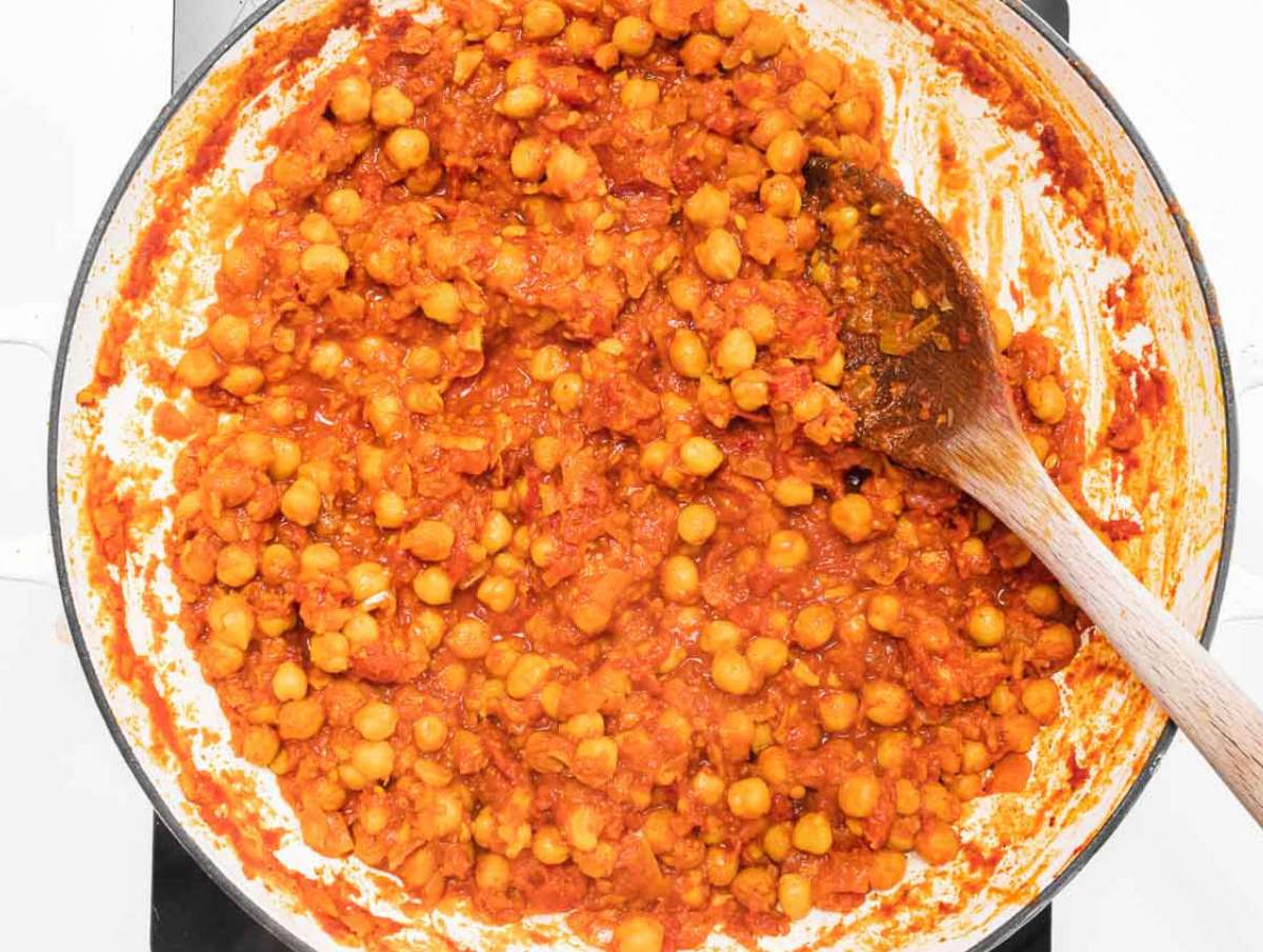 Step 3 Canned tomatoes and broth simmering with chickpeas until thick and flavorful.