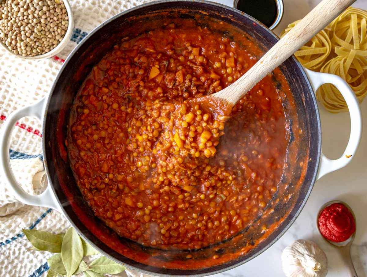Step 3 Green or brown lentils simmering with tomato pureฬe and vegetable stock until tender and the Bolognese has thickened.
