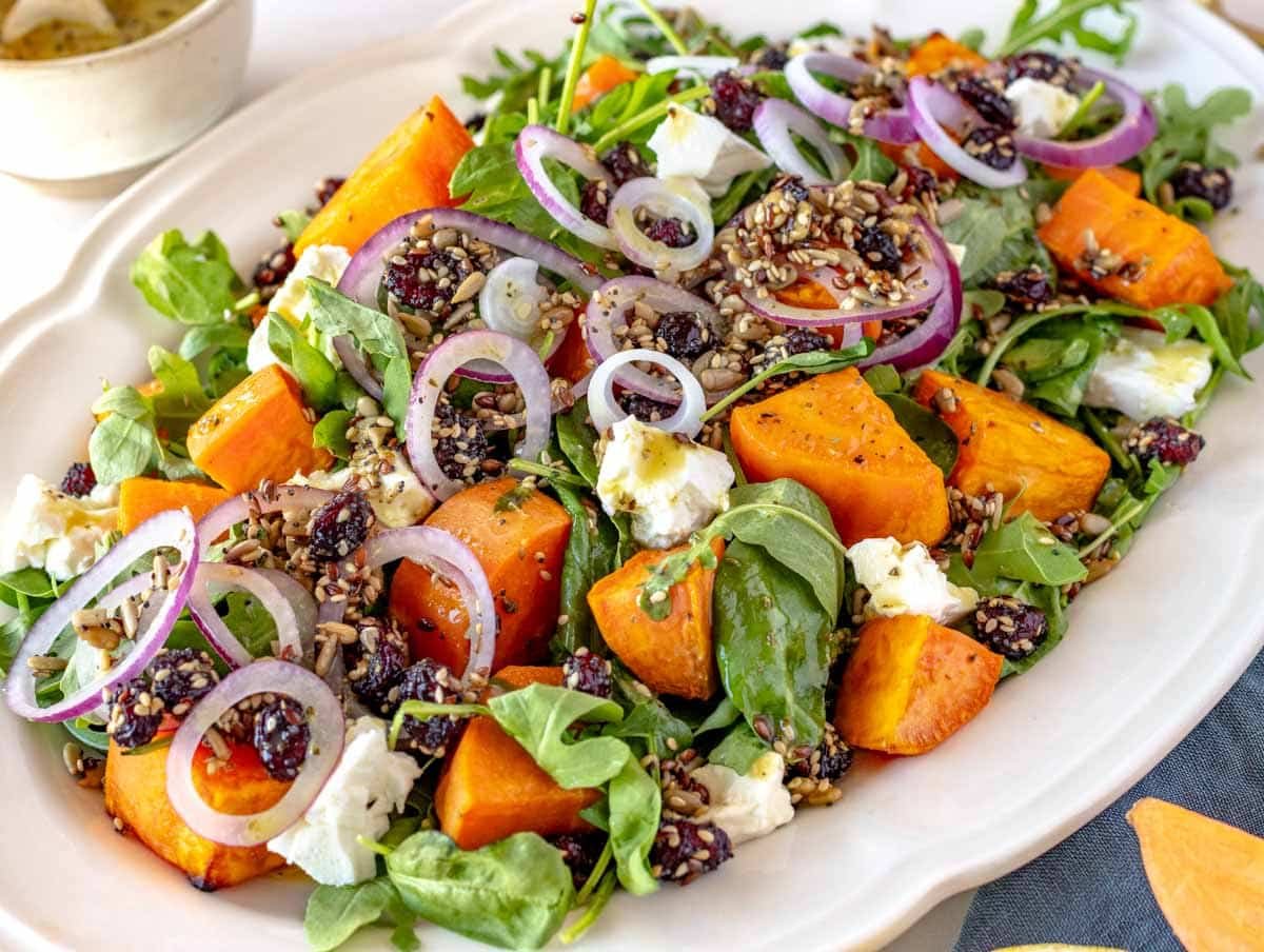 roasted sweet potato salad with arugula, spinach, cranberries, and feta