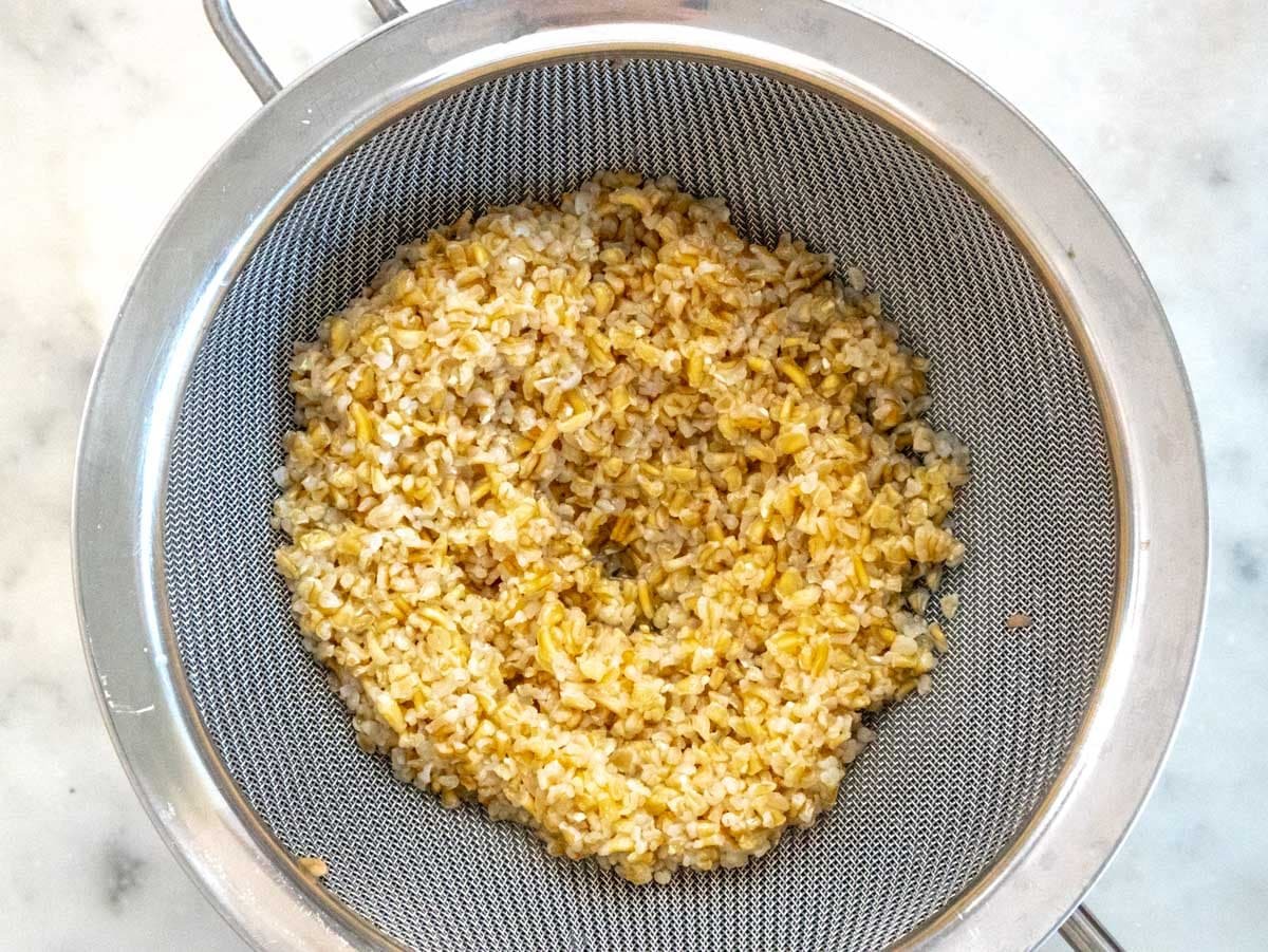 cooked bulgur in a strainer