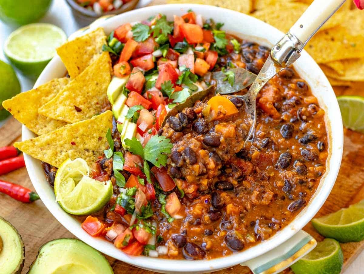 black bean soup with toppings and a spoon