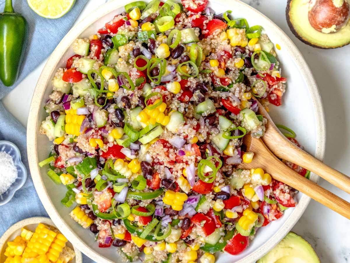 quinoa salad in a white bowl after mixing ingredients