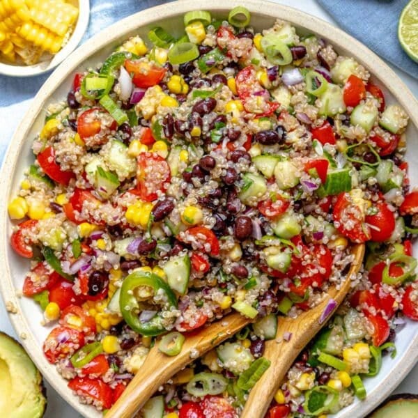 quinoa salad in a white bowl with beans and fresh vegetables