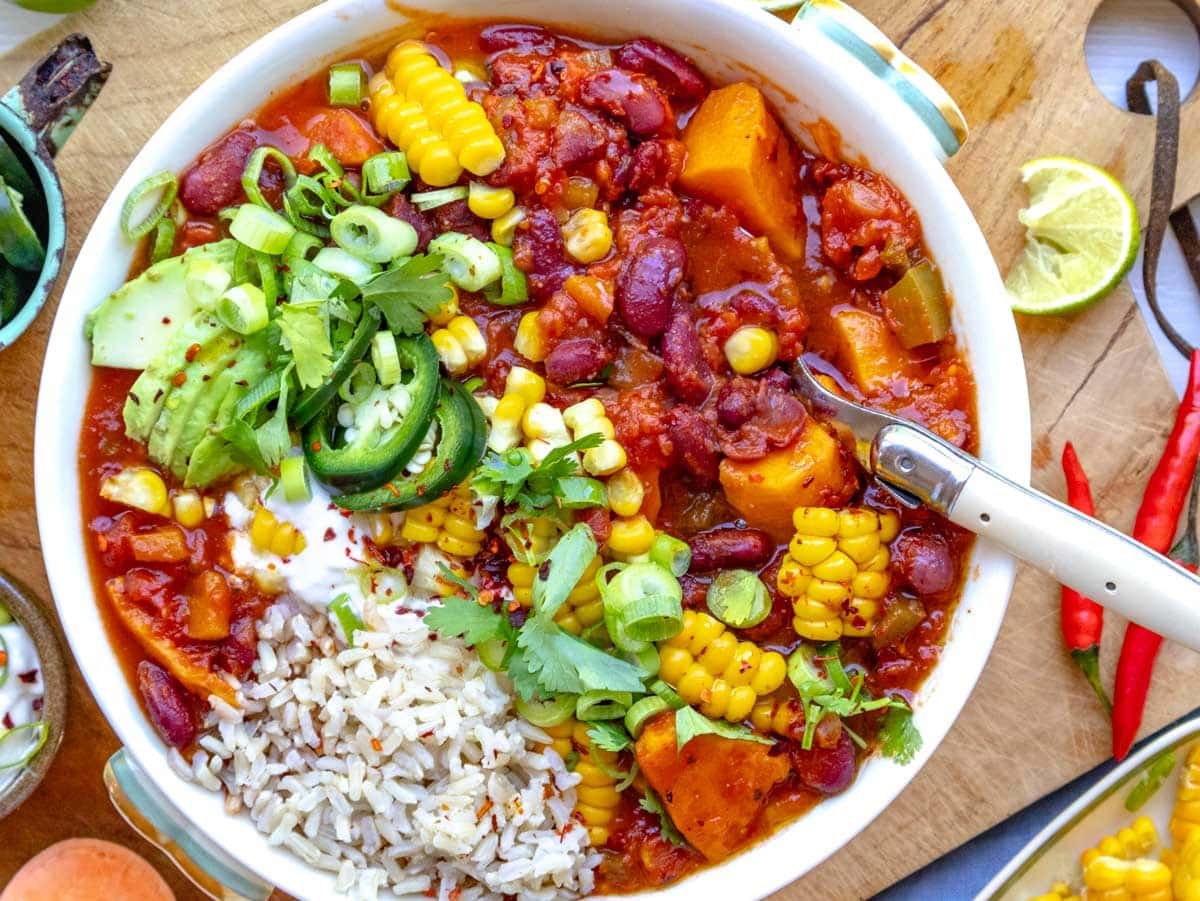 sweet potato chili served with rice and topped with jalapeños, sour cream, and corn