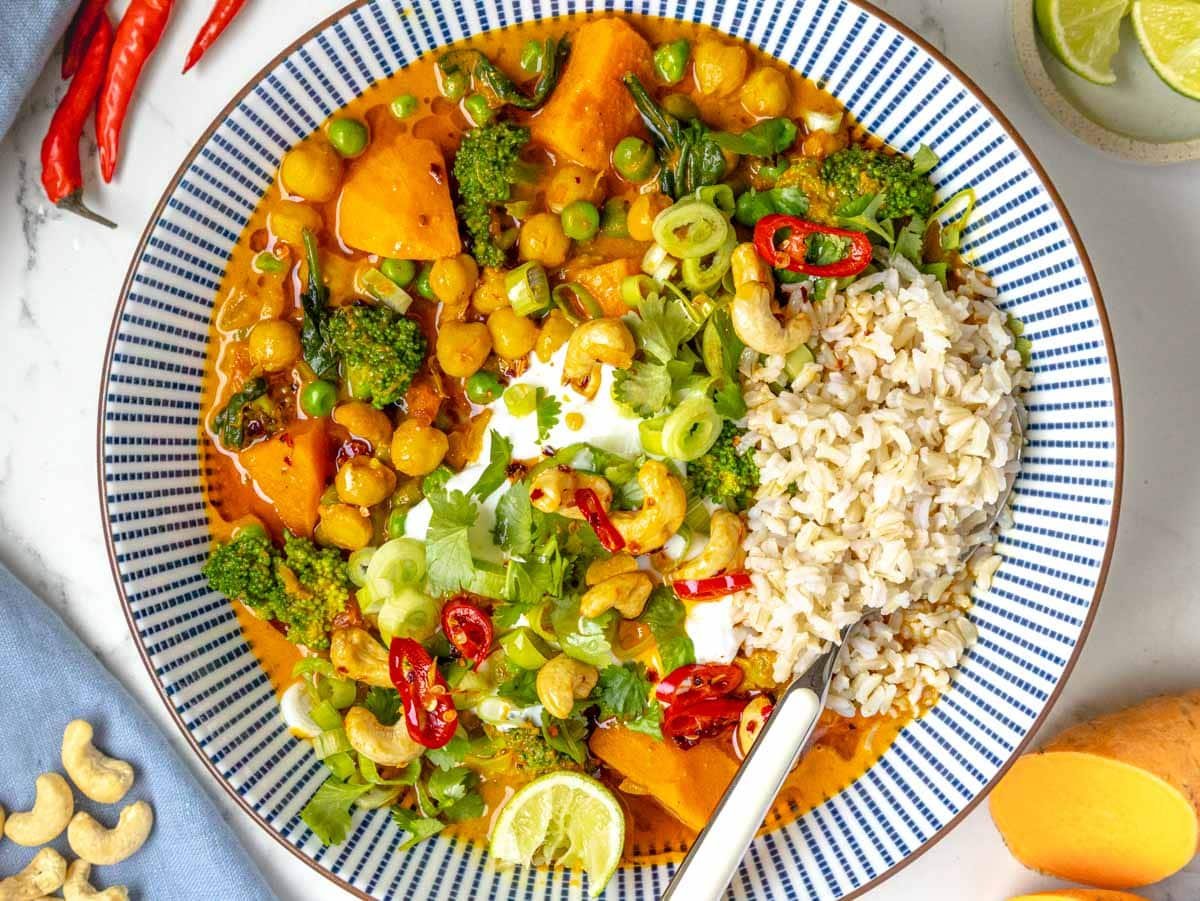 vegetable curry in a blue bowl with rice