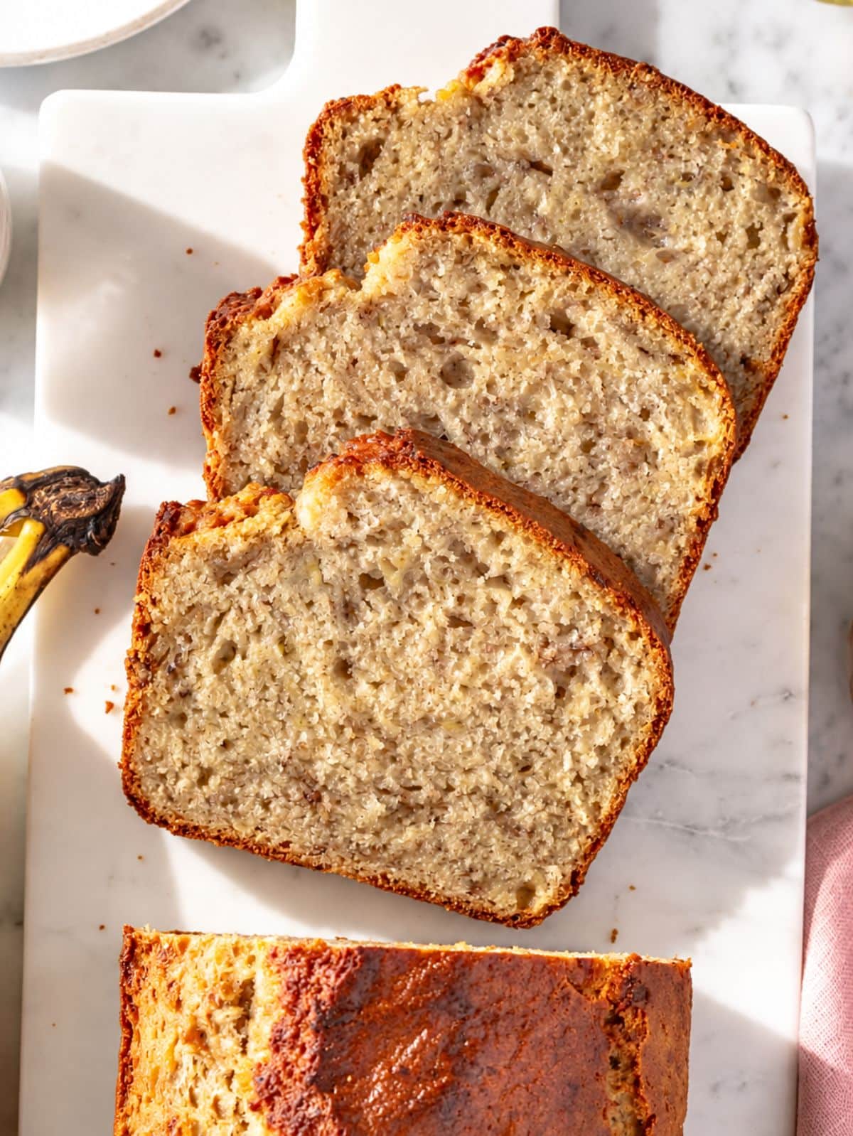 Flat lay of vegan banana bread showing its tender, moist banana crumb.