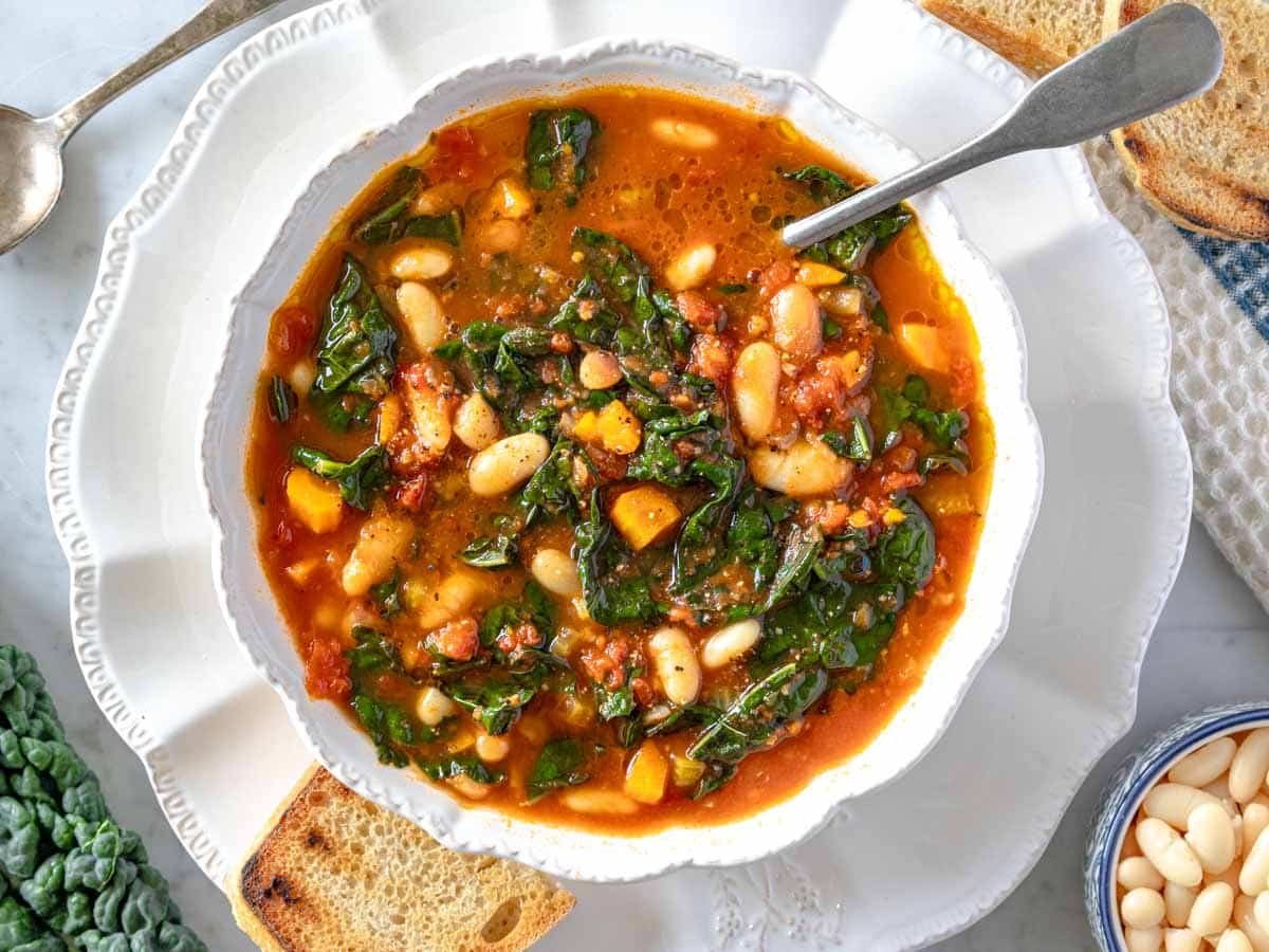 creamy kale soup in a white porcelain bowl