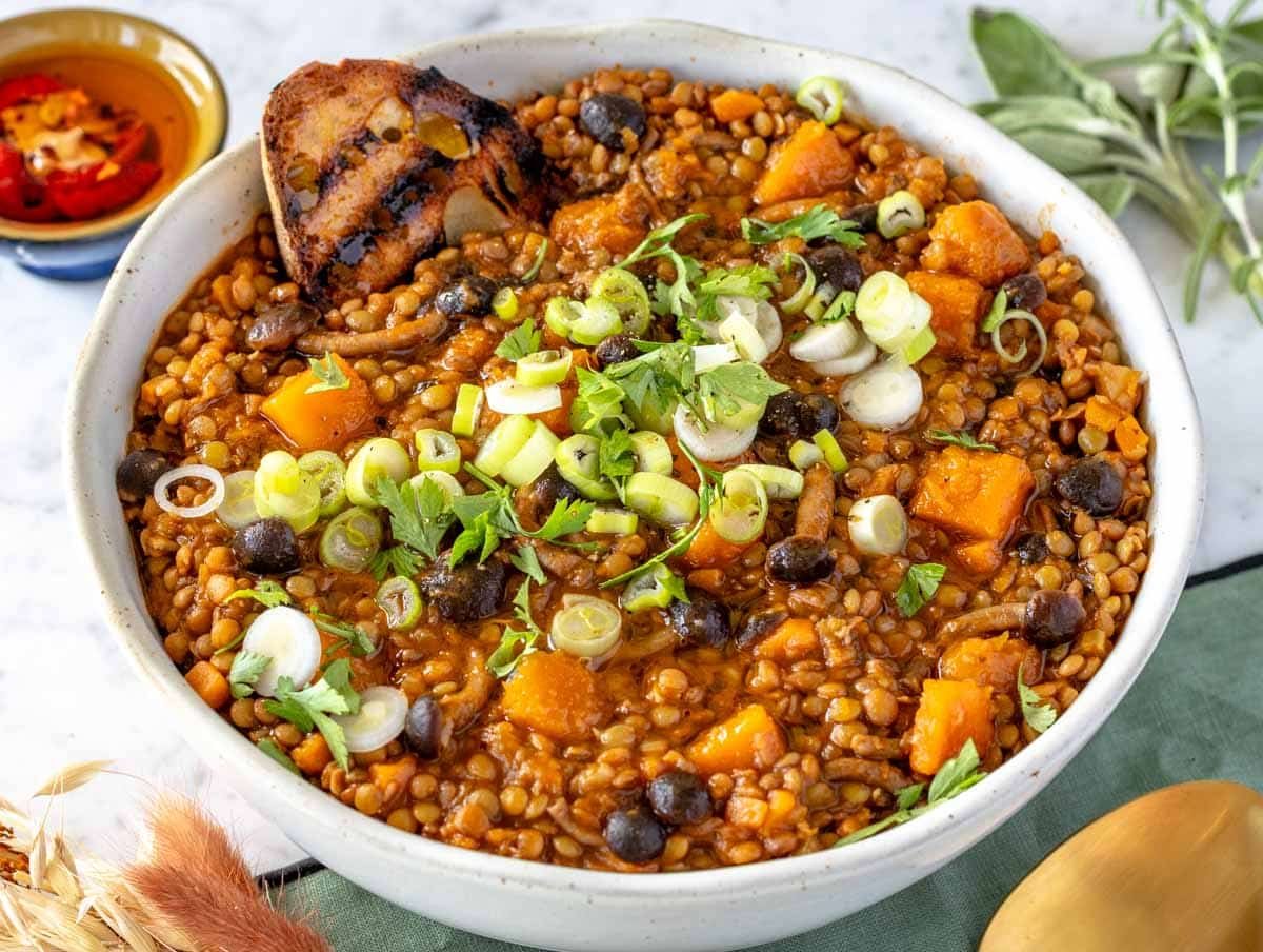 lentil stew in a bowl with crusty bread