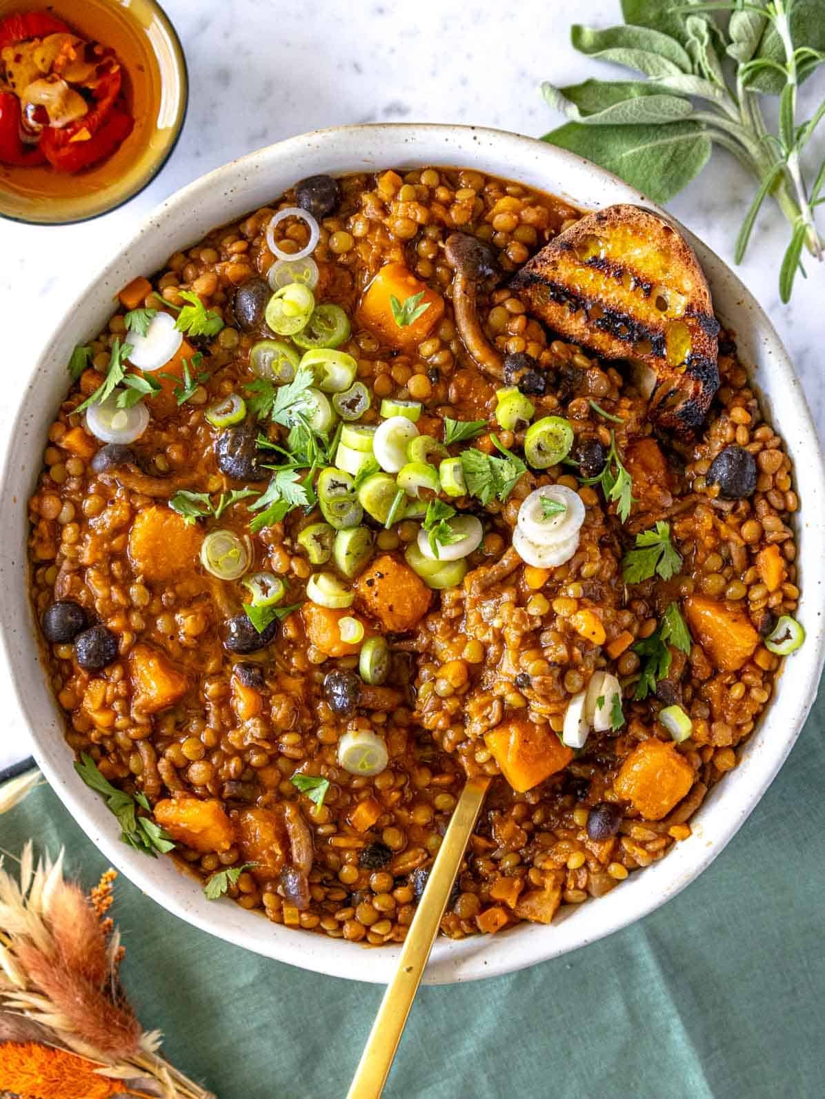 Lentil stew with toasted bread and a golden spoon