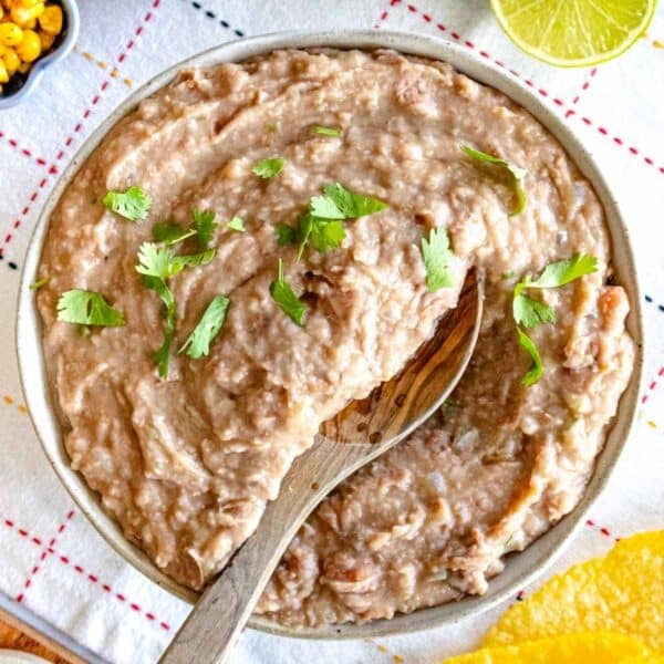 Refried beans with cilantro and a wooden spoon