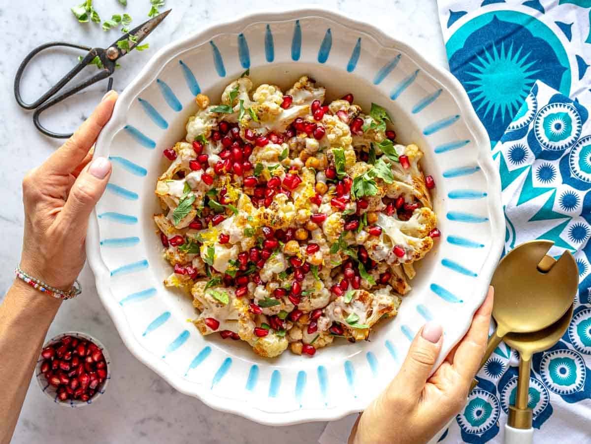 Louise holding a bowl with cauliflower salad