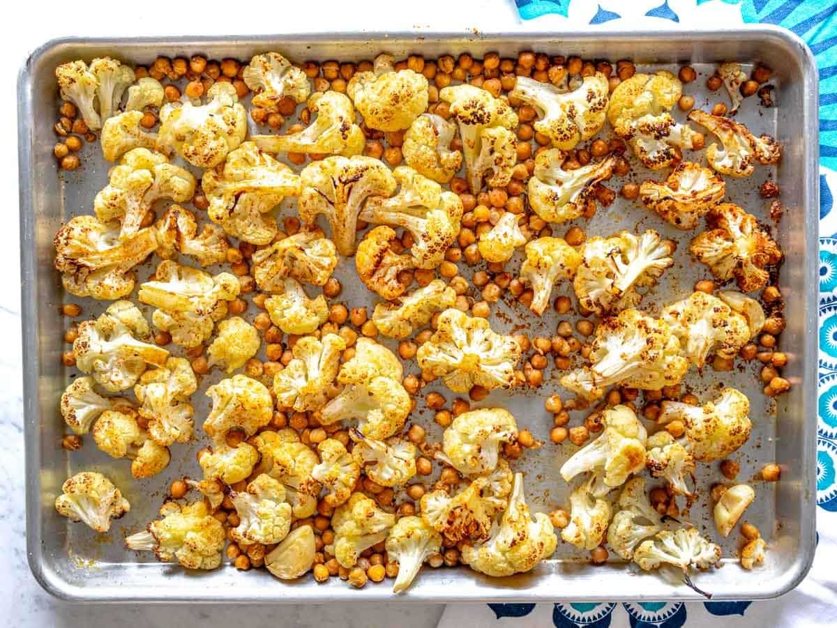 roasted chickpeas and cauliflower on a baking tray