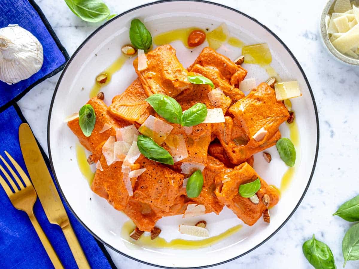 creamy roasted red pepper pasta topped with basil and parmesan