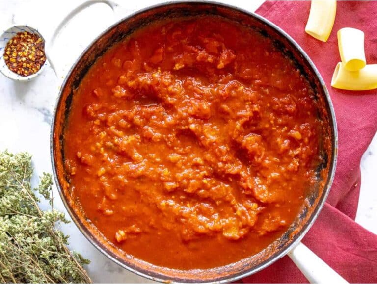 Step 2 Onion garlic and tomatoes simmering in pan for pasta alla Norma sauce.