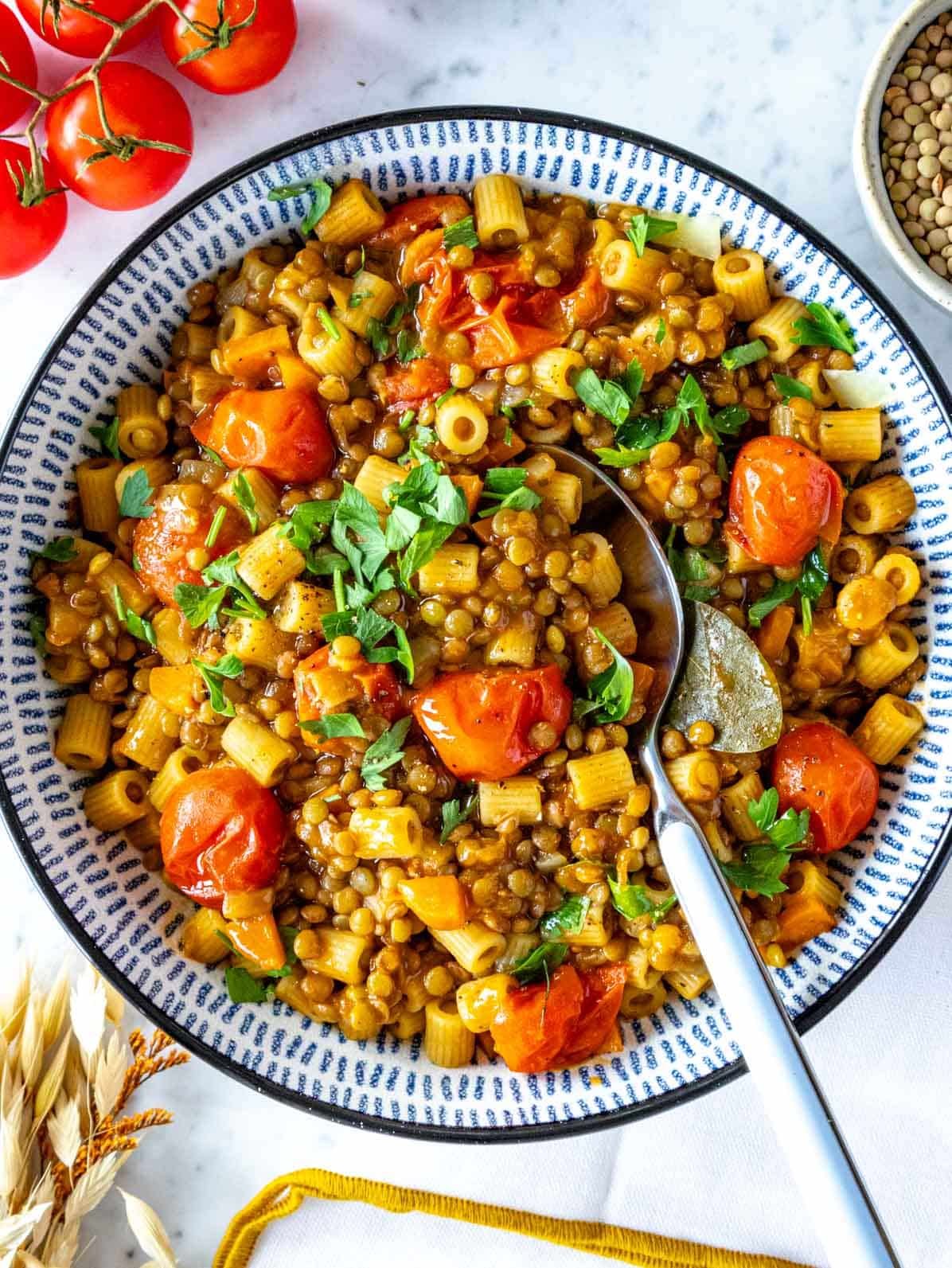 lentil pasta in a blue bowl served with a spoon