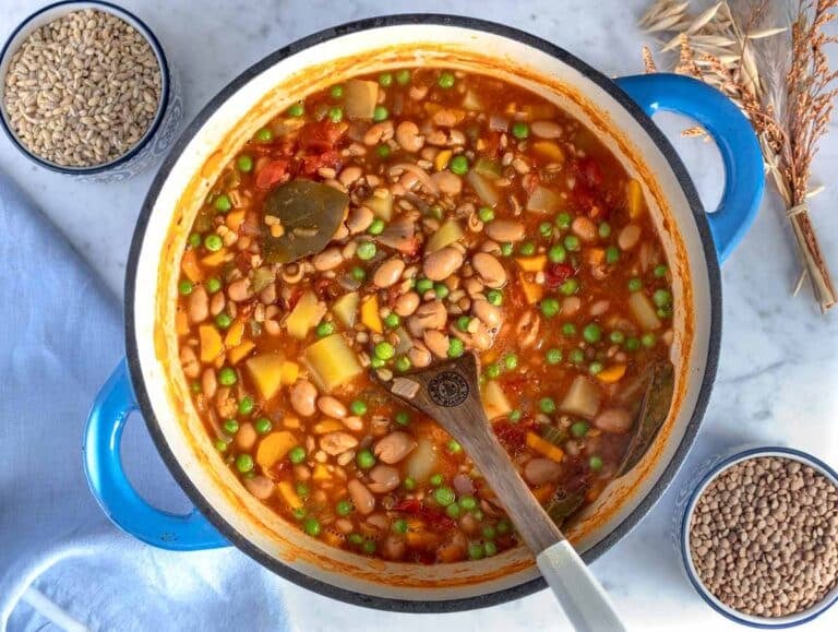 Creamy barley soup in a blue pot.