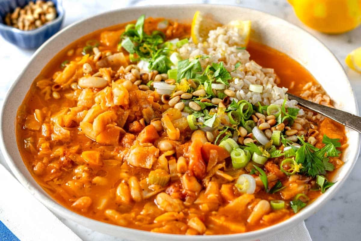 cabbage soup topped with rice, yogurt, and lemon zest