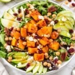 Colorful butternut squash salad with marinated chickpeas, apple, feta, and pecans.