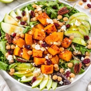Colorful butternut squash salad with marinated chickpeas, apple, feta, and pecans.