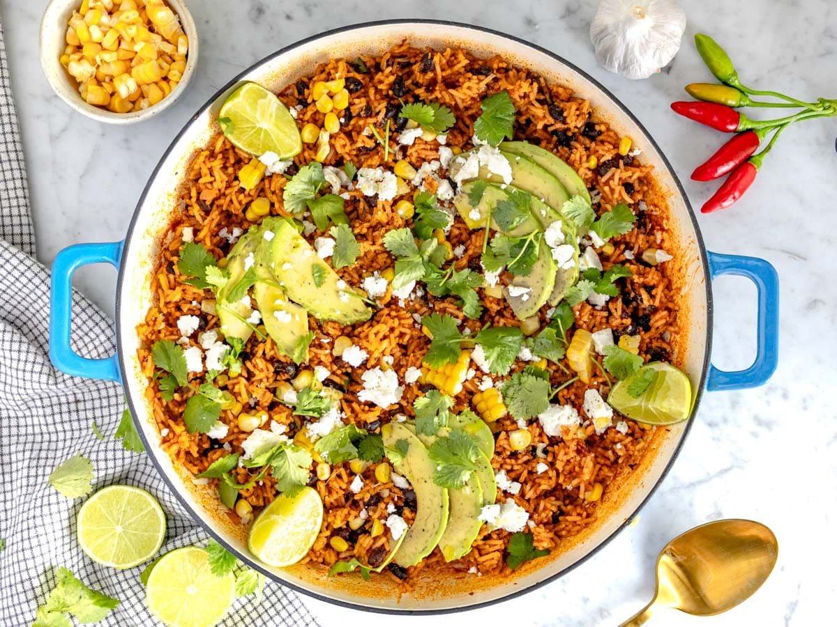 Mexican rice topped with avocado, queso fresco, lime juice, corn, and cilantro.