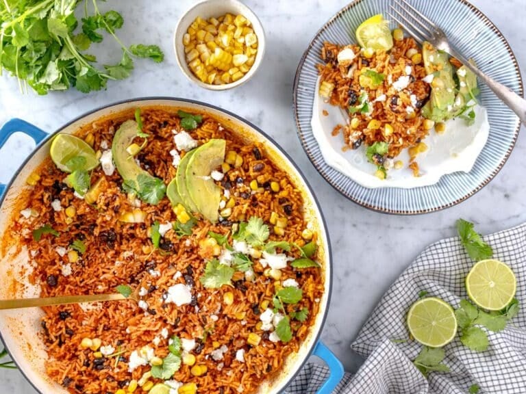 Mexican rice in a skillet and one portion on a plate.