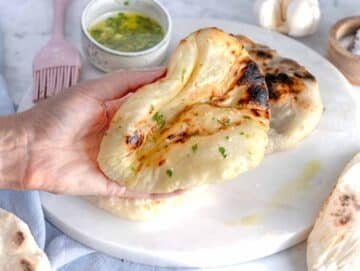 Louise holding a soft naan bread