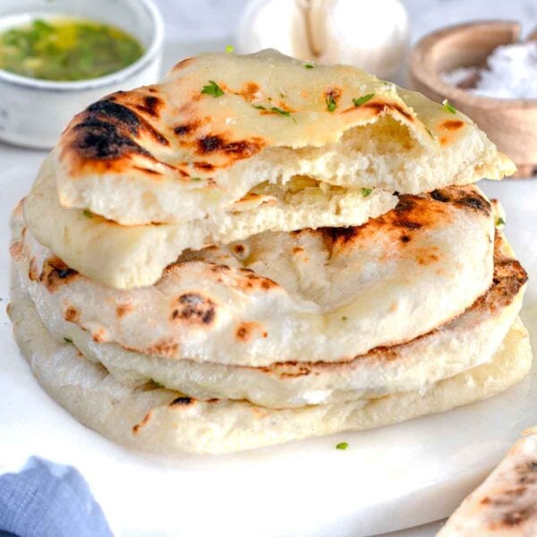 Naan bread stacked on a marble plate