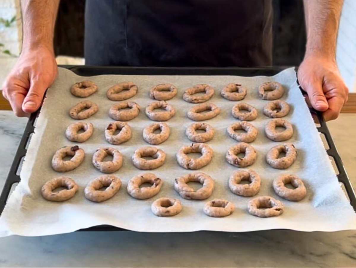 Nico with wine cookies on a baking tray